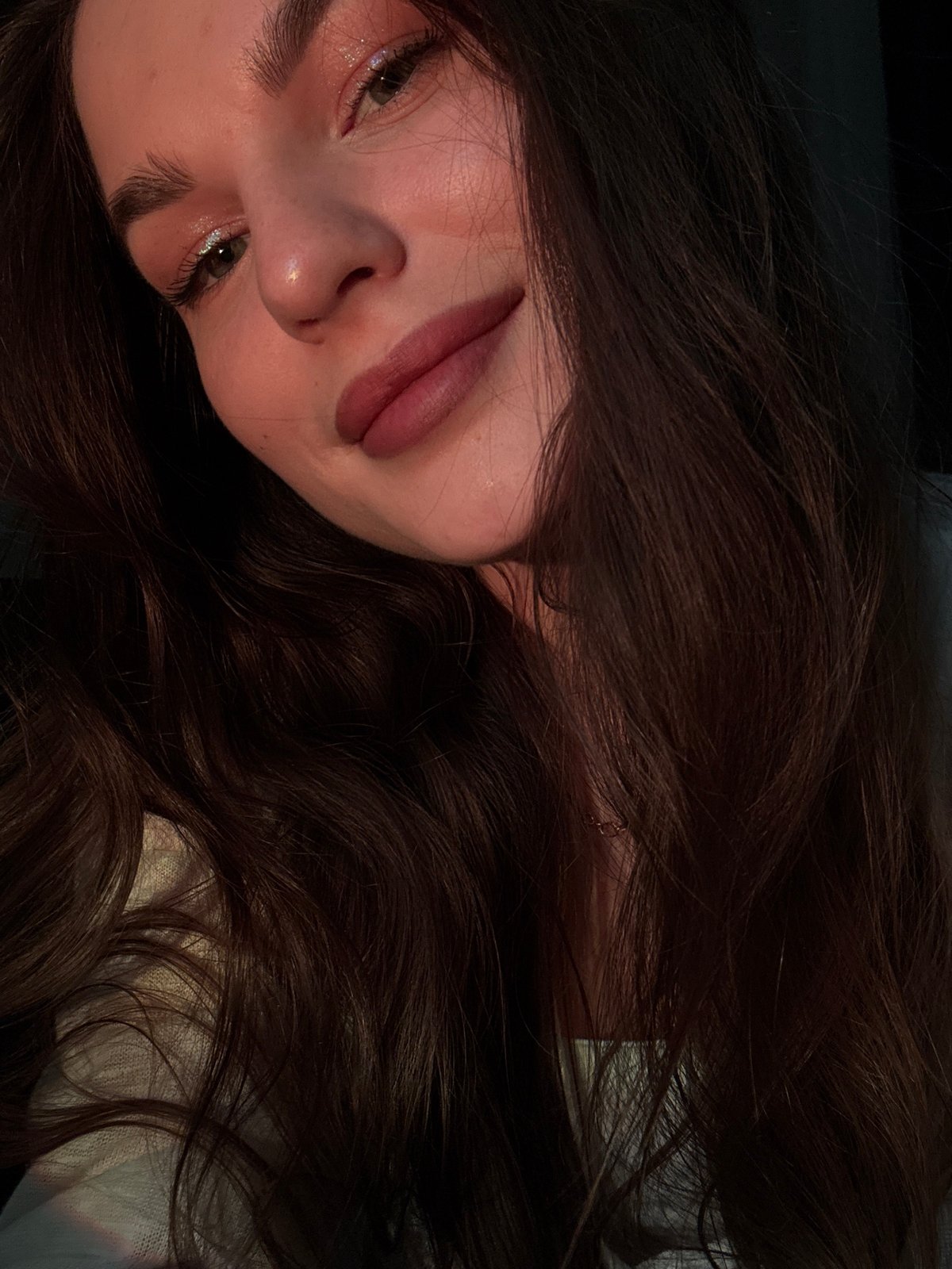 Woman takes selfies in dimly lit Chaikovsky room