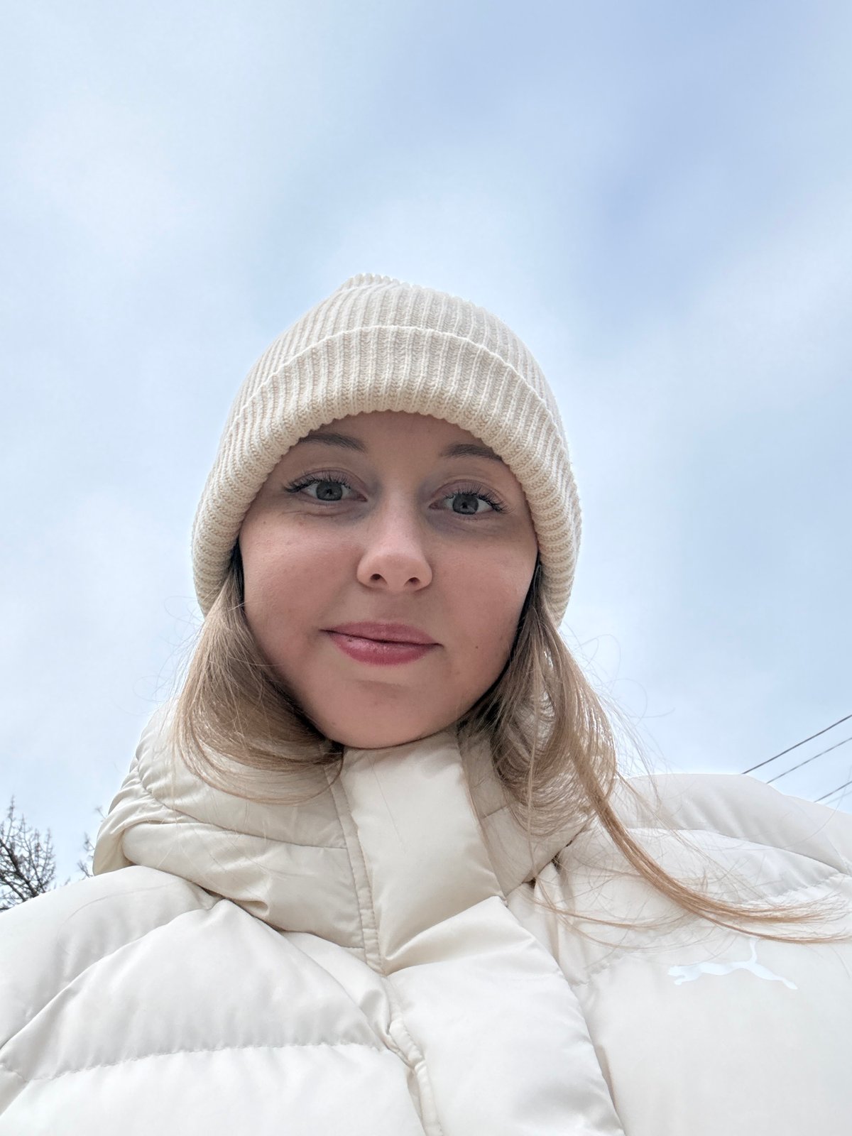 Woman in cream jacket, electric scooters captured same area