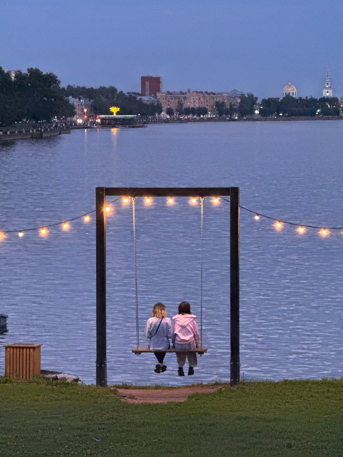 Evening at Votkinsk's waterfront: domes, docks, and a surf bar