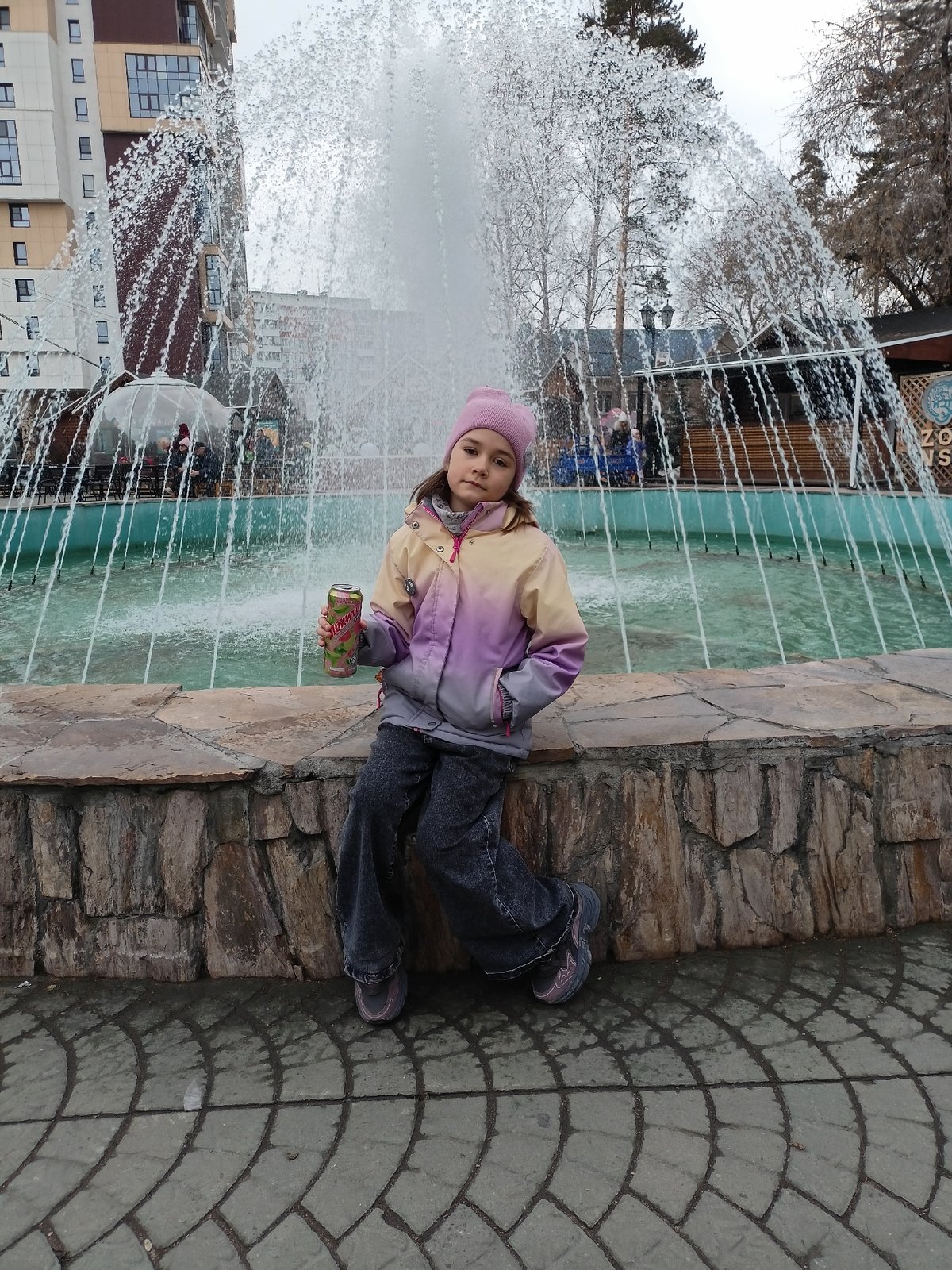 Girl visits dinosaur park in early morning Novosibirsk