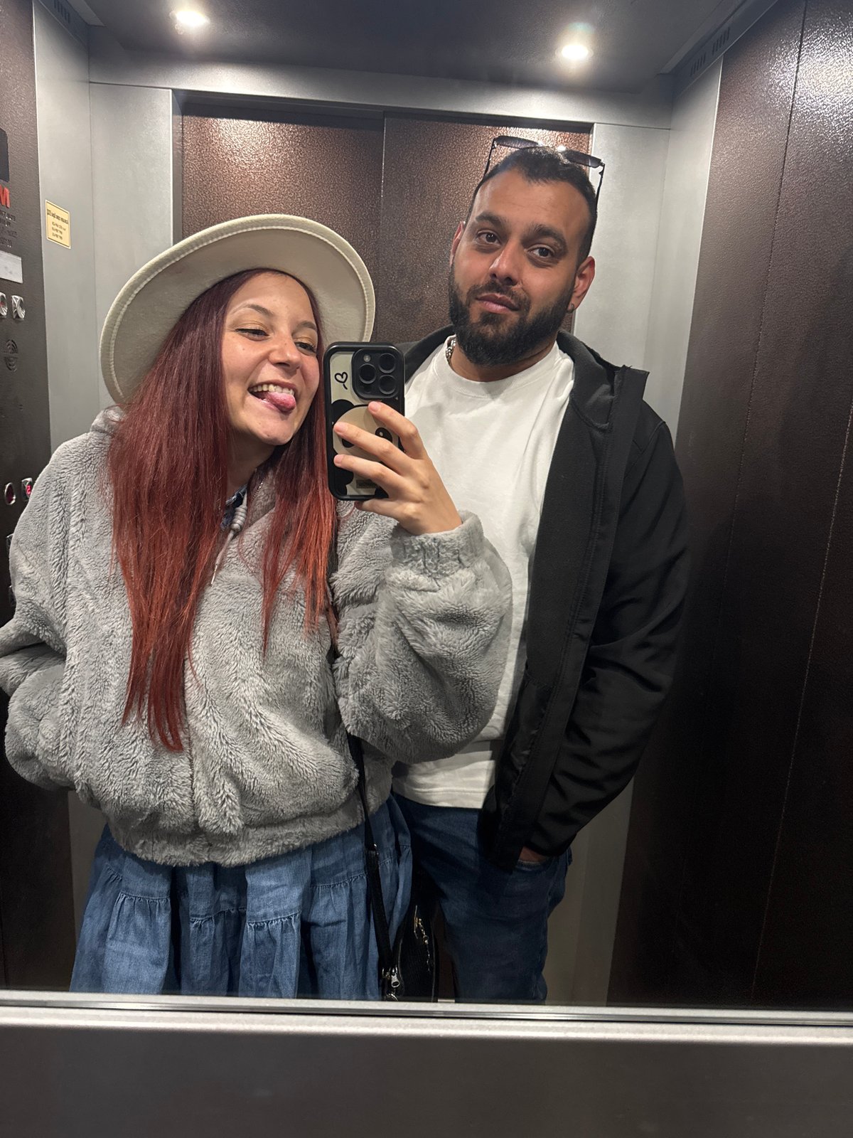Couple captures mirror selfie moment in elevator