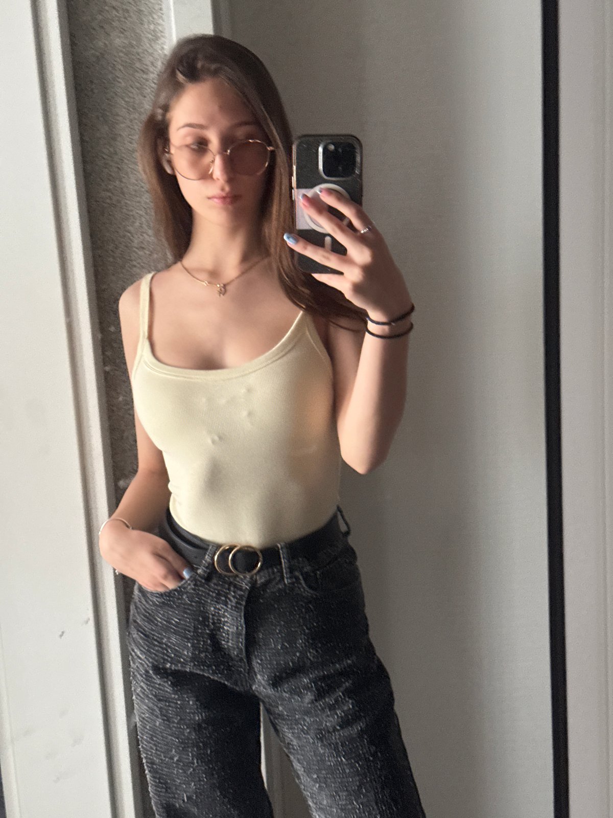 Woman takes mirror selfie in Sofia wearing trendy outfit