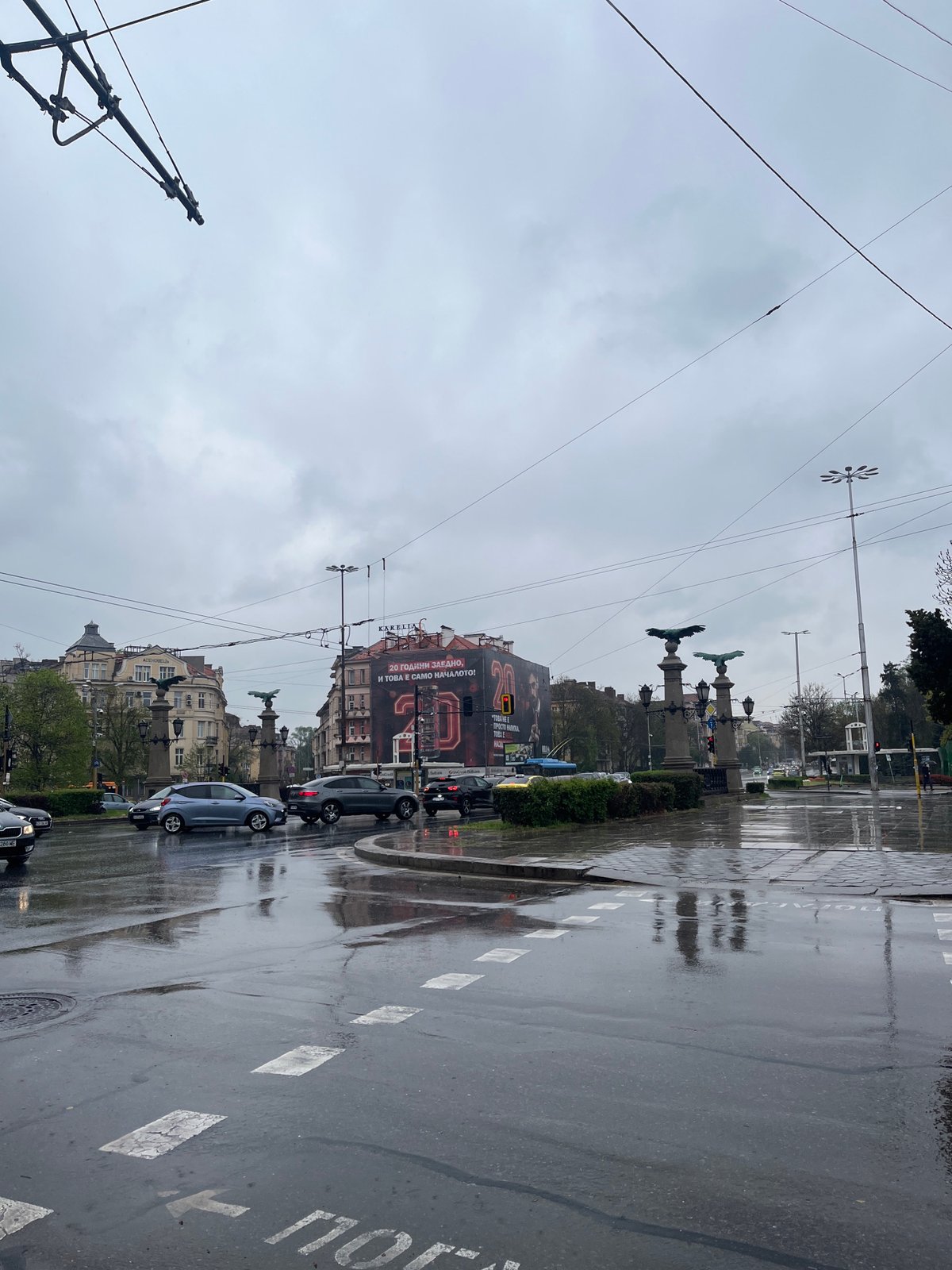 Rainy morning documented across Sofia streets, pedestrians use umbrellas