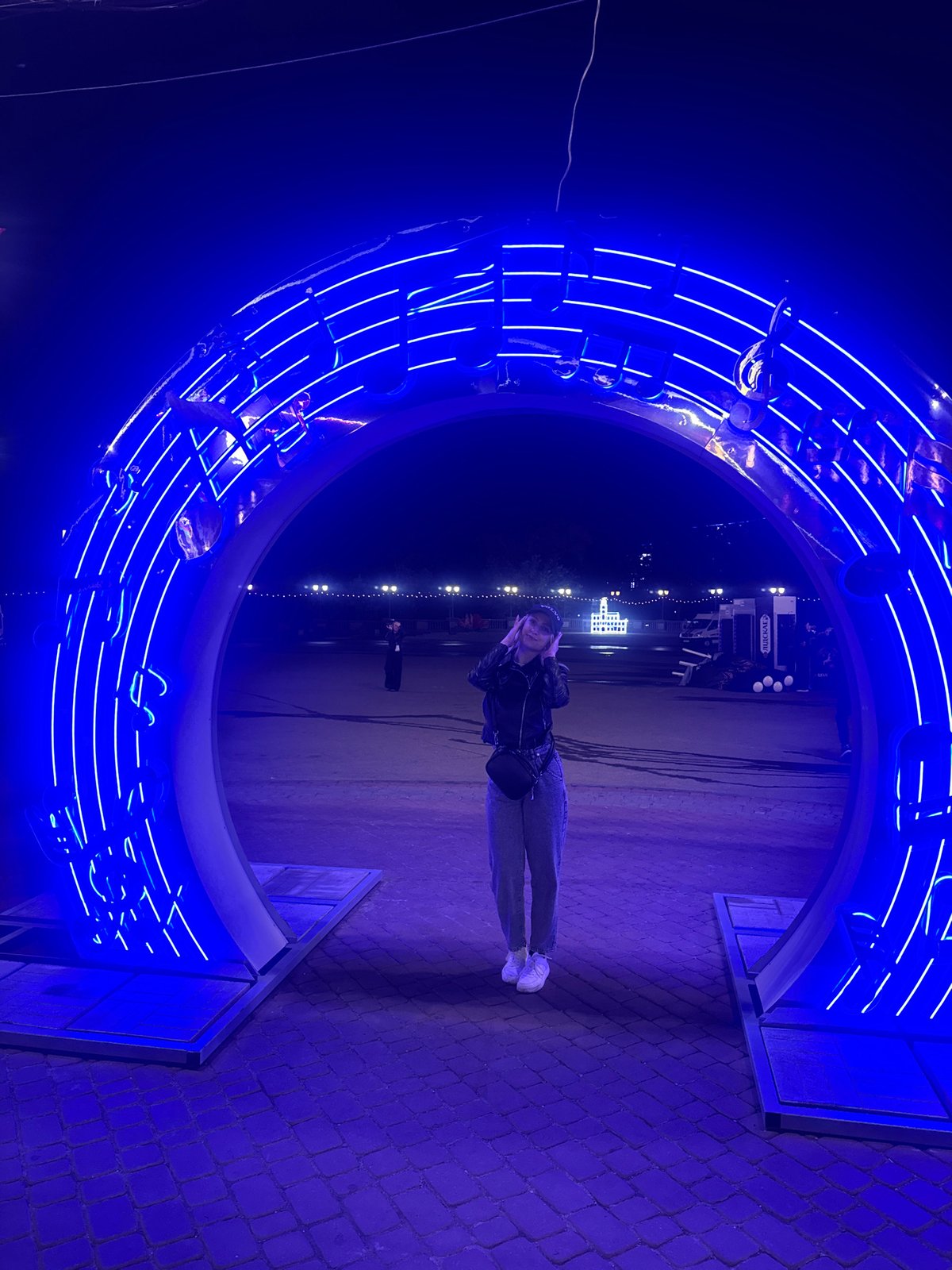 Blue neon music installation and Eastern European street at night