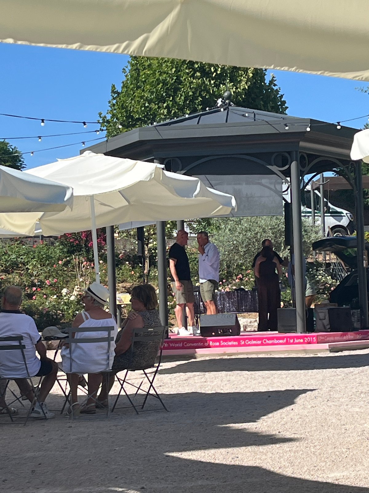 Outdoor gathering with stage and seated crowd in Chambœuf