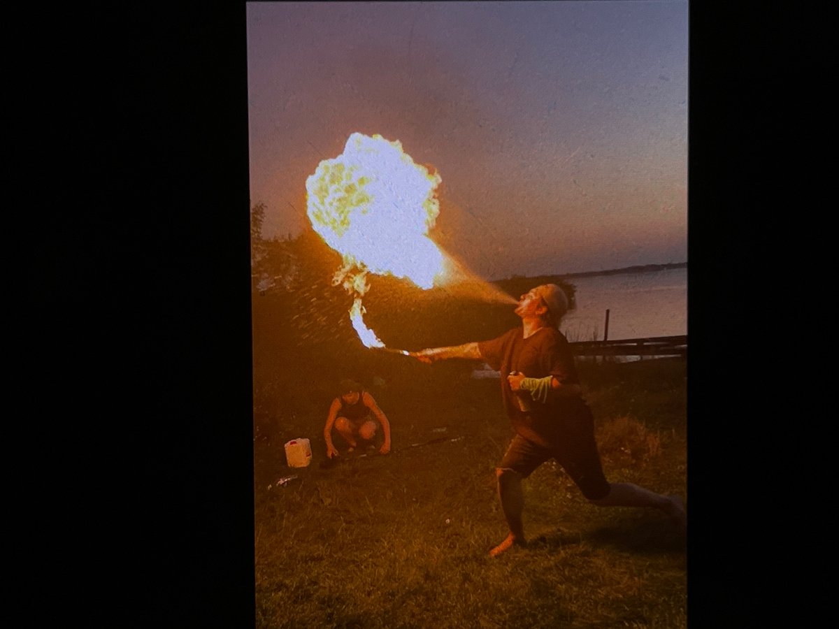 Fire performers work the Tyumen riverbank at dusk