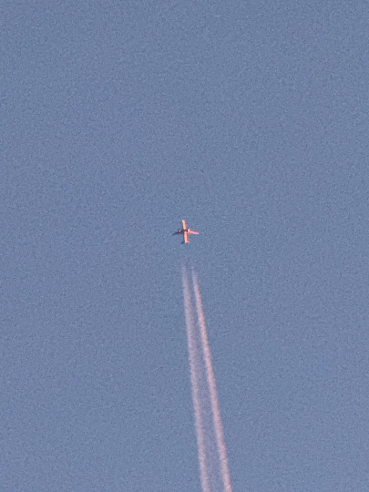 Planes, contrails, and a full moon over Norilsk skies