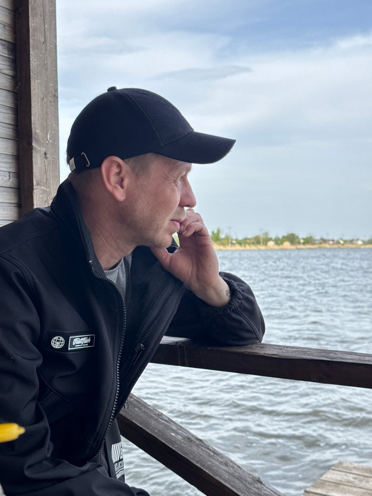 Man fishing from wooden dock captured by witnesses