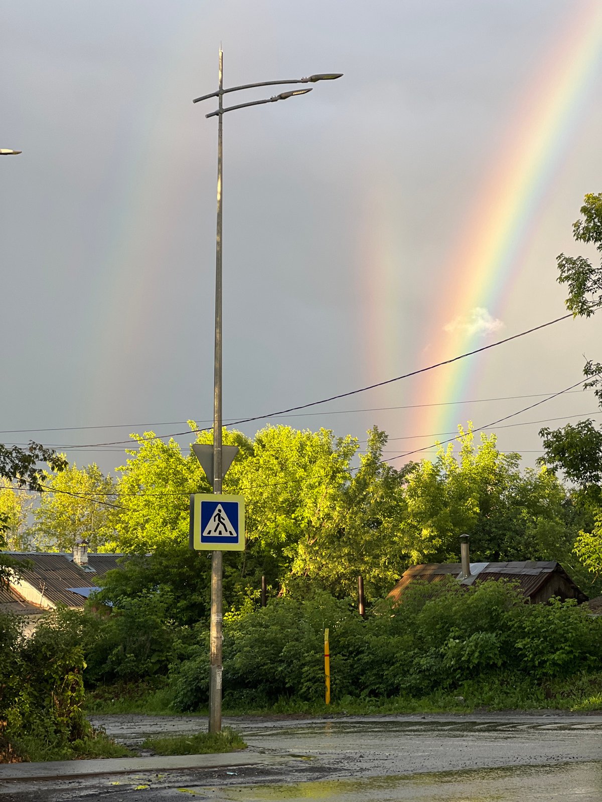 Double rainbow over wet Izhevsk streets after a summer rain