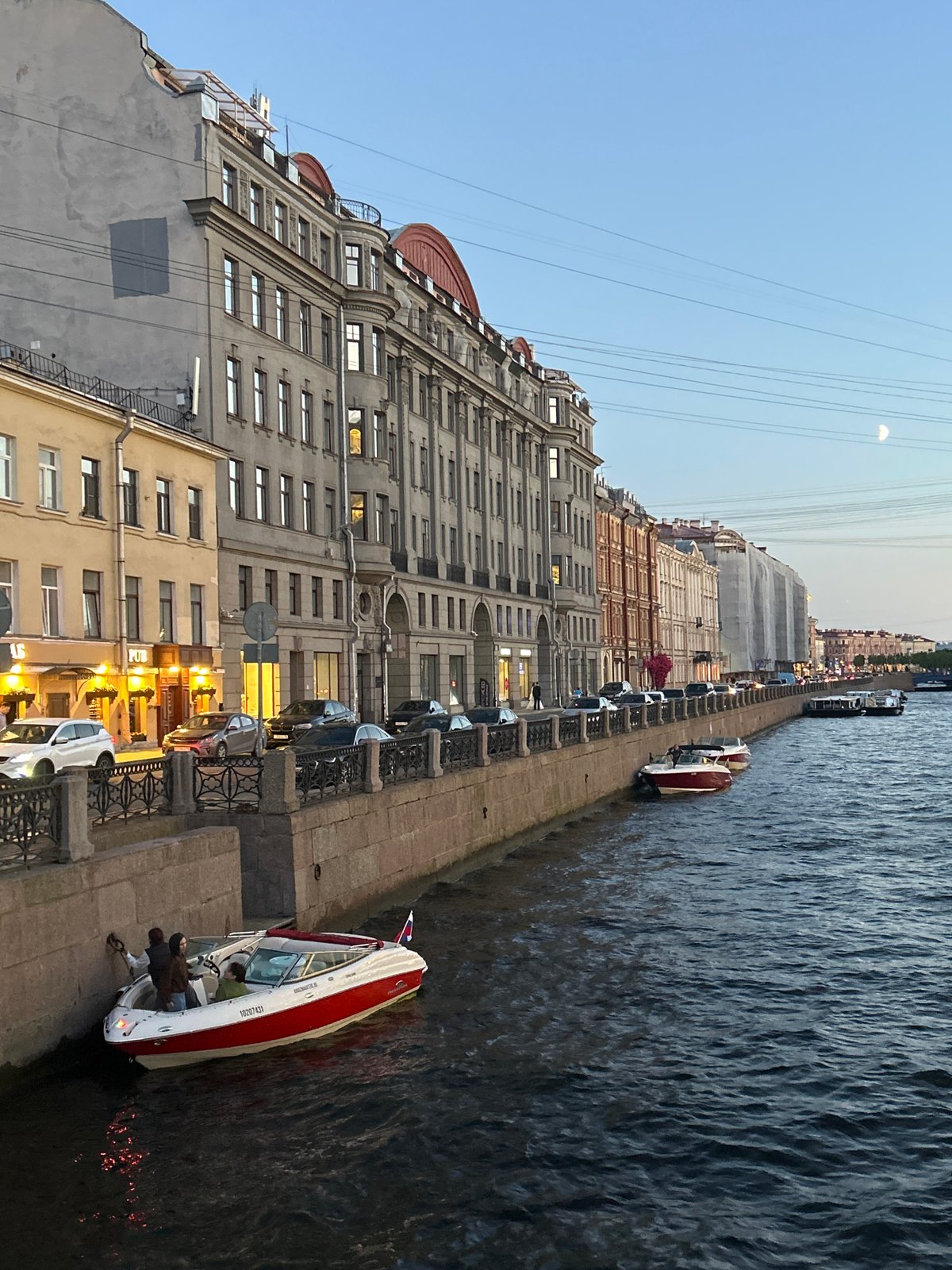 Dusk along a European canal city's waterfront streets