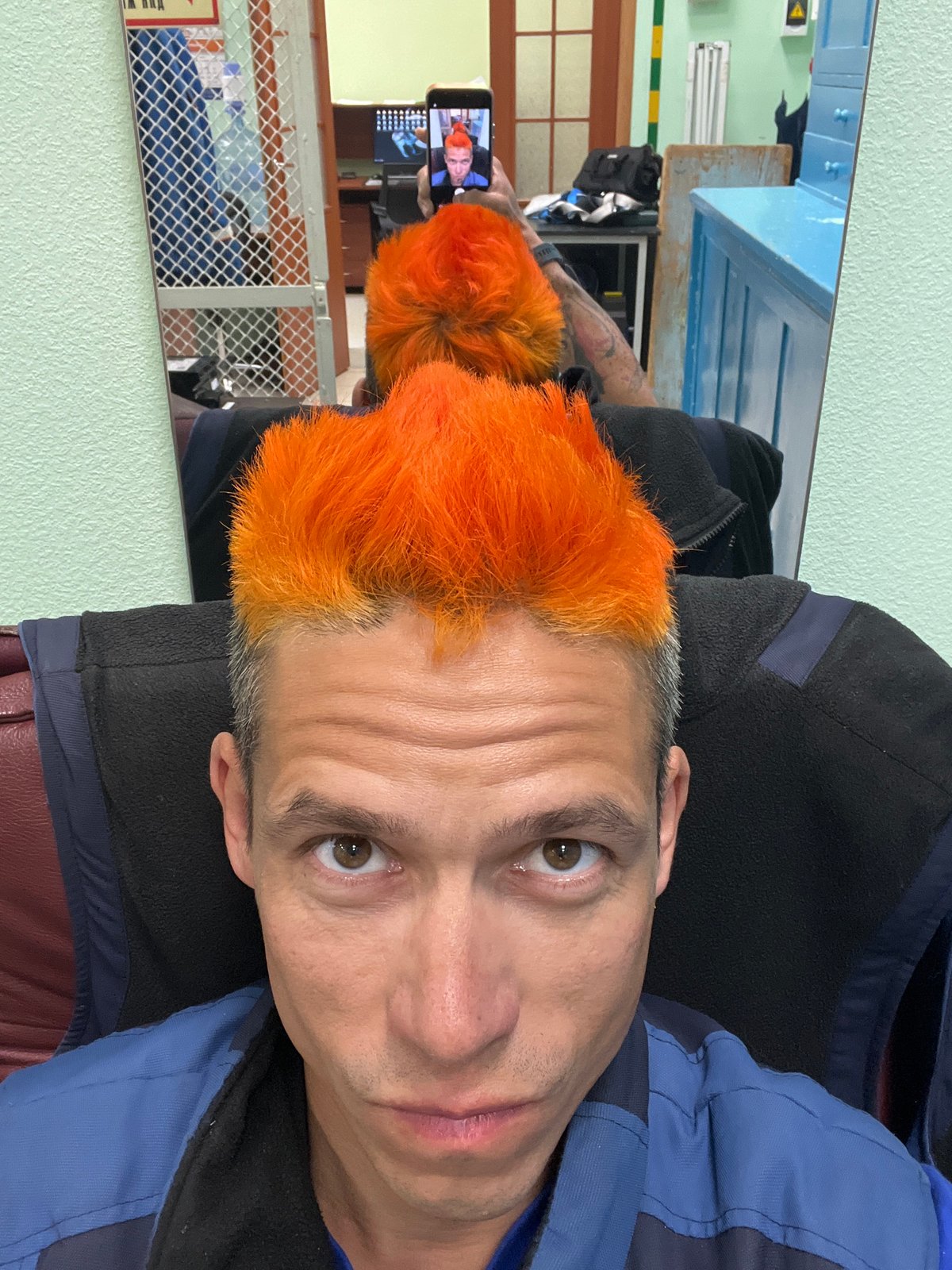 Orange-haired man photographed at mirror in Chaikovsky, Russia