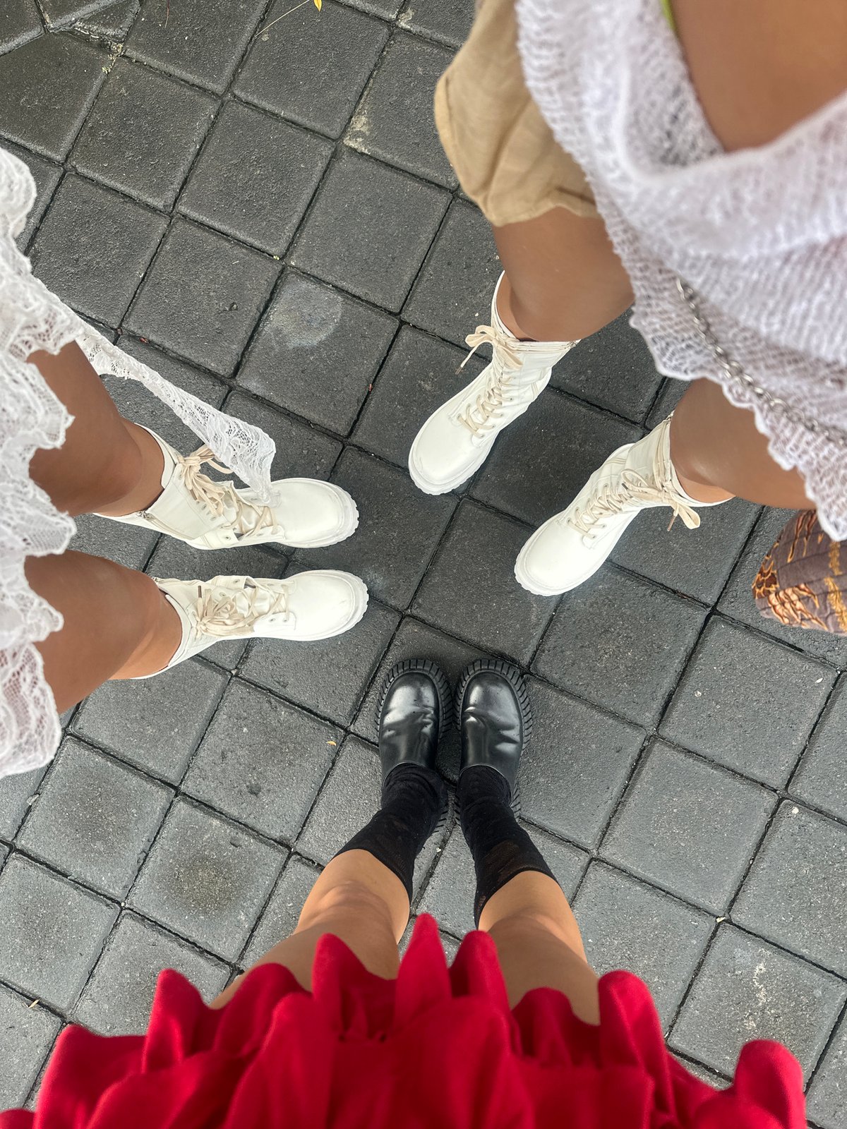 Four people gather on tiled surface in North Kuta