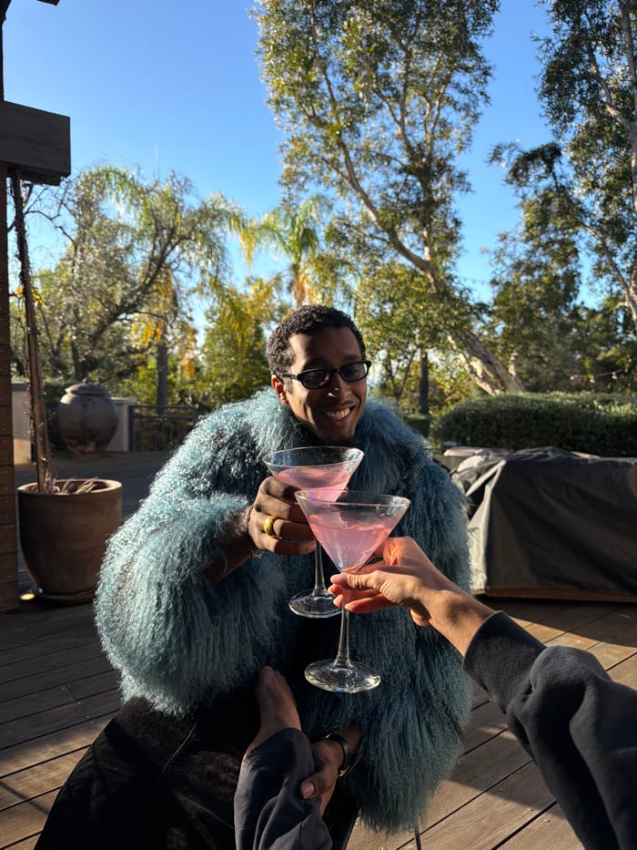 Couple shares pink cocktails on Los Angeles deck