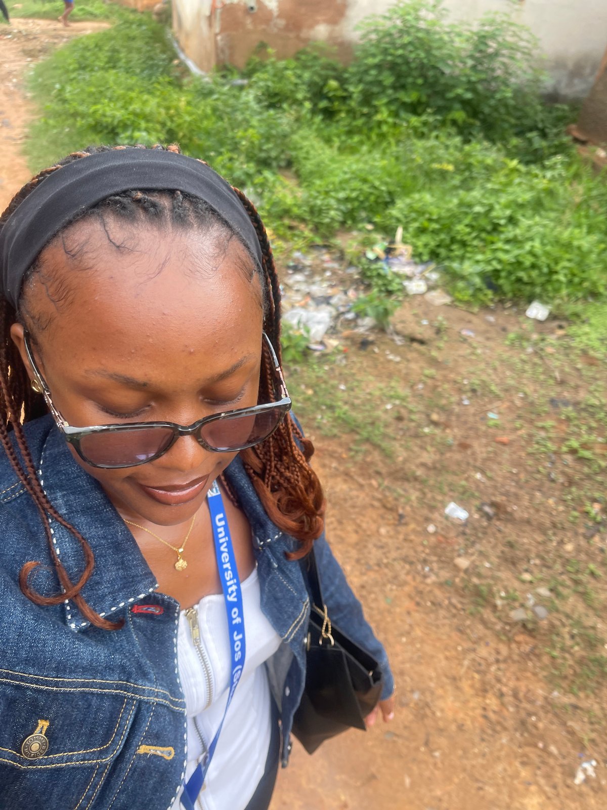 University of Jos student taking selfies on a dirt path in Rafin Par
