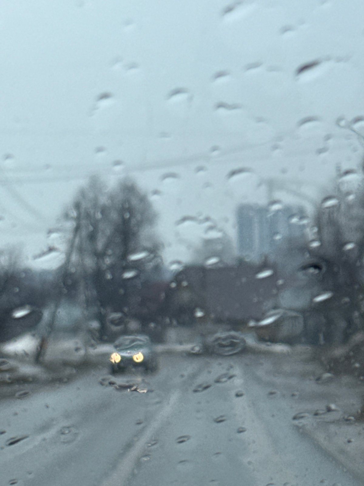 Rainy street scene viewed through window in Chaikovsky, Russia