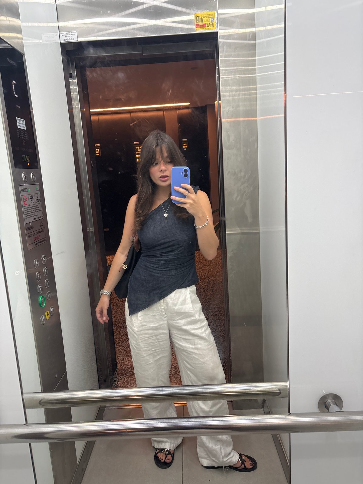 Woman takes elevator selfie in Tel Aviv morning