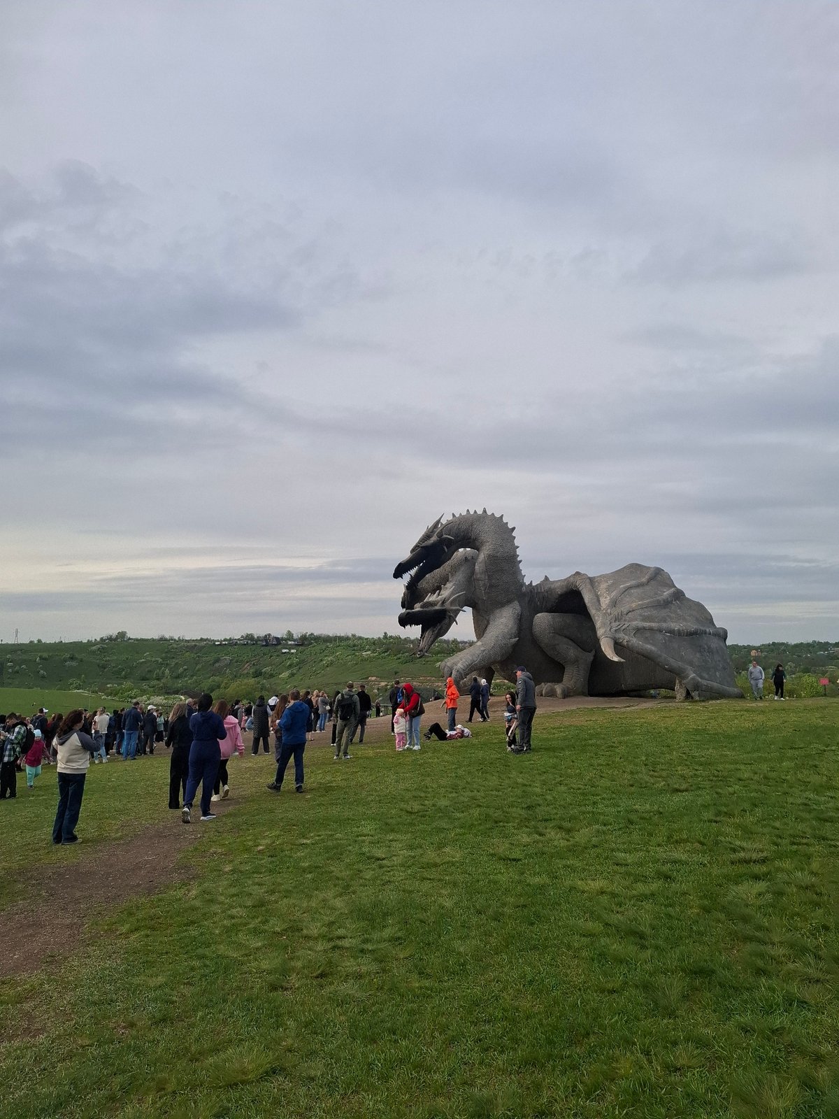 Visitors gather at dragon sculpture park in Алисово, Russia