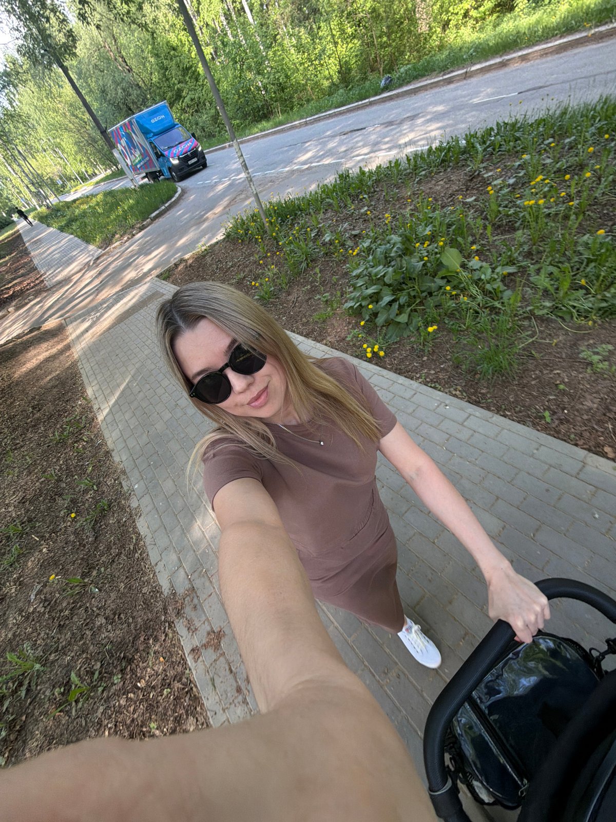 Mother and baby stroll through Chaikovsky park, Russia