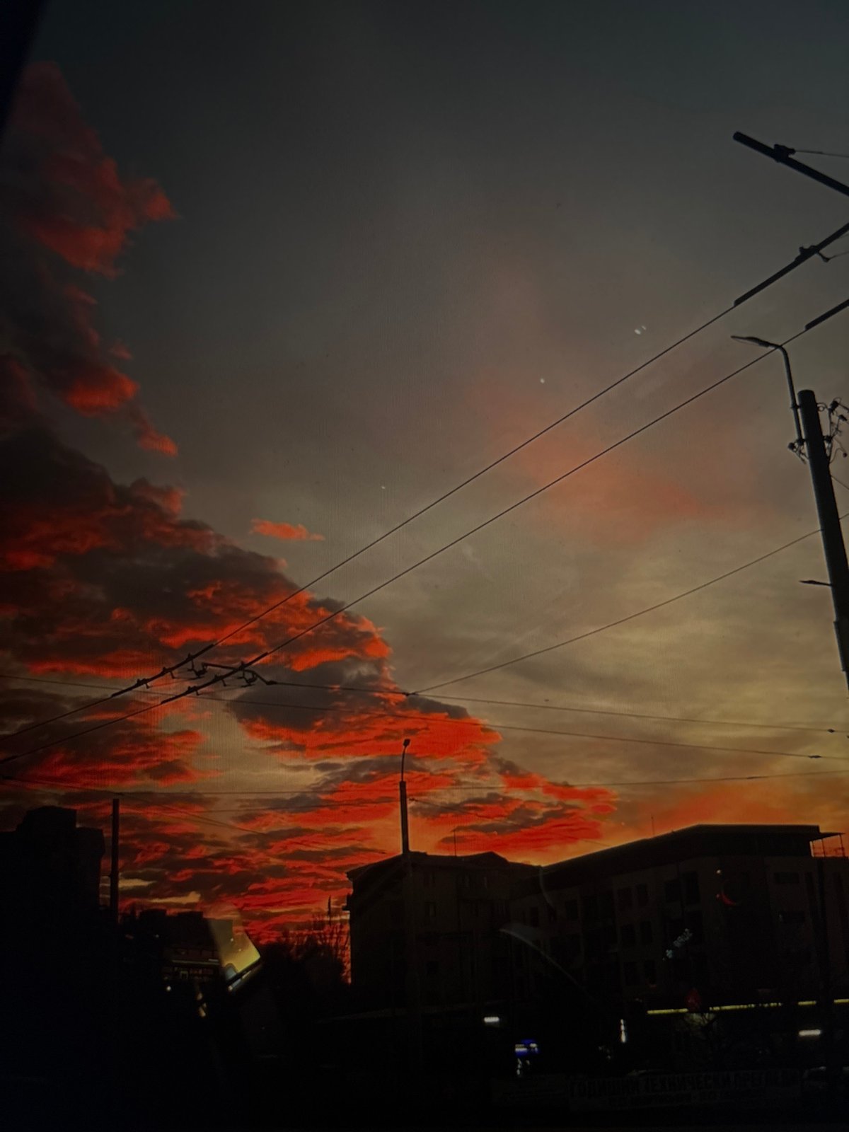 City sunset documented with utility infrastructure visible at dusk