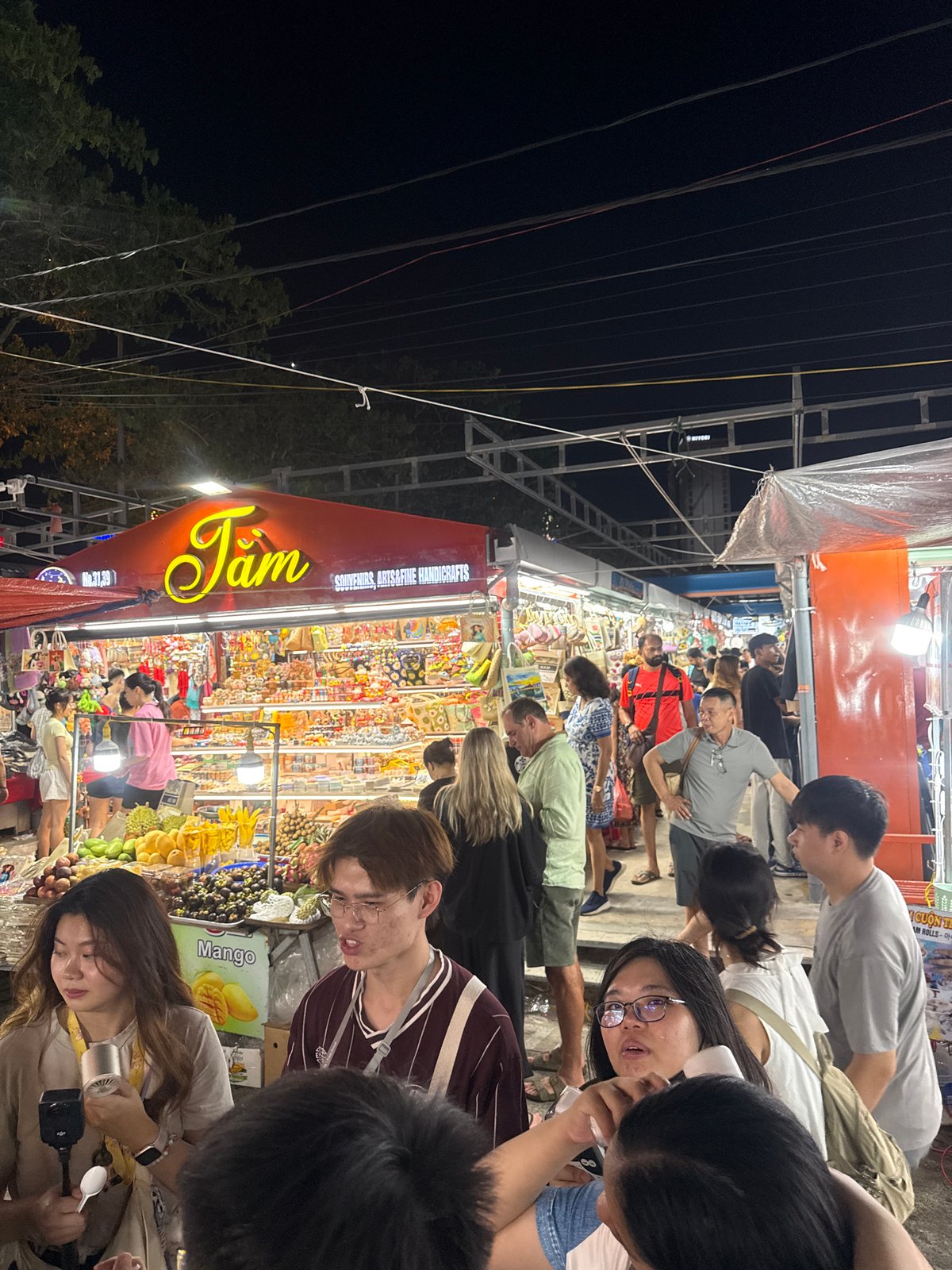 Night market activity and Dragon Bridge illumination in Da Nang