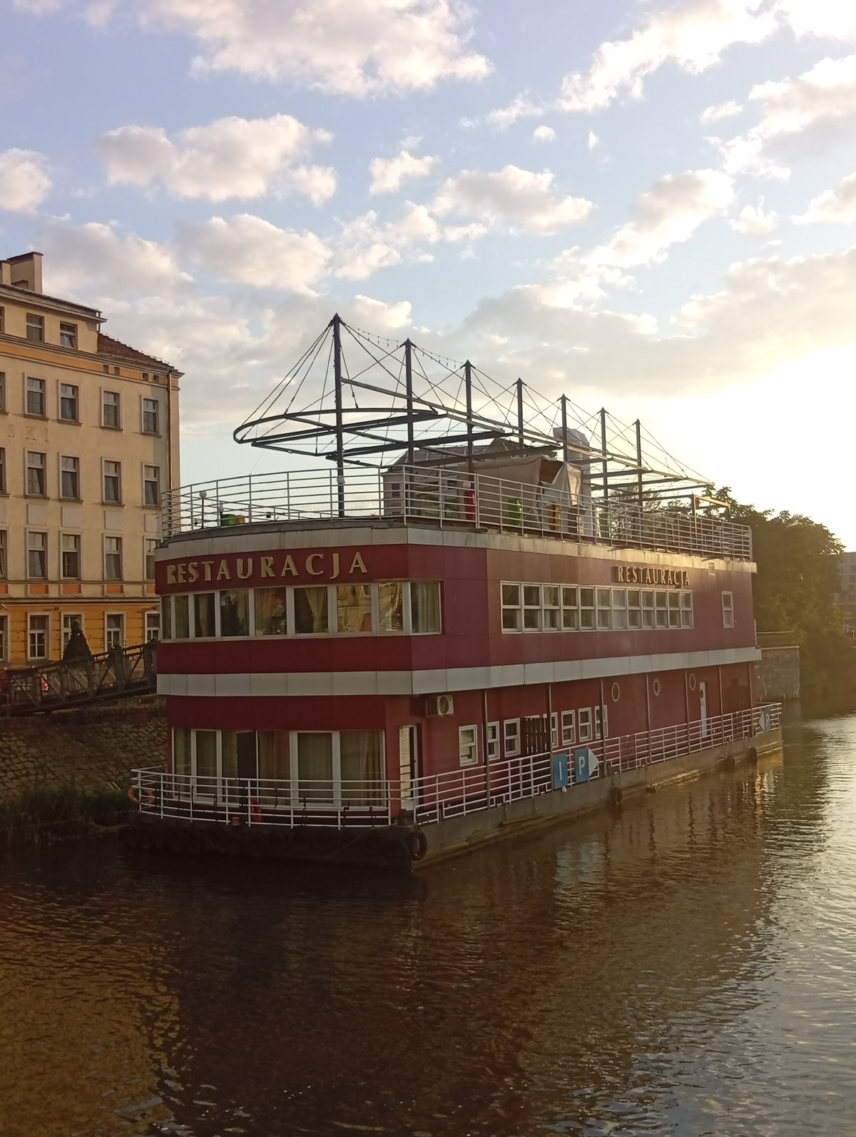 Wrocław's Oder riverfront at golden hour, bridges to gnomes