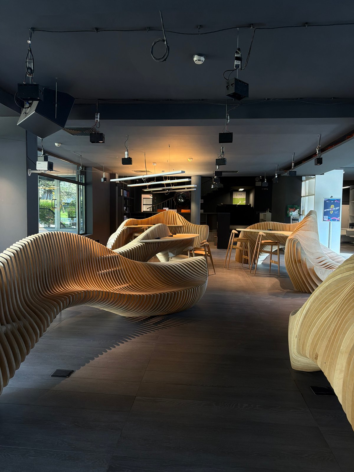 Curved wooden installations documented in interior space