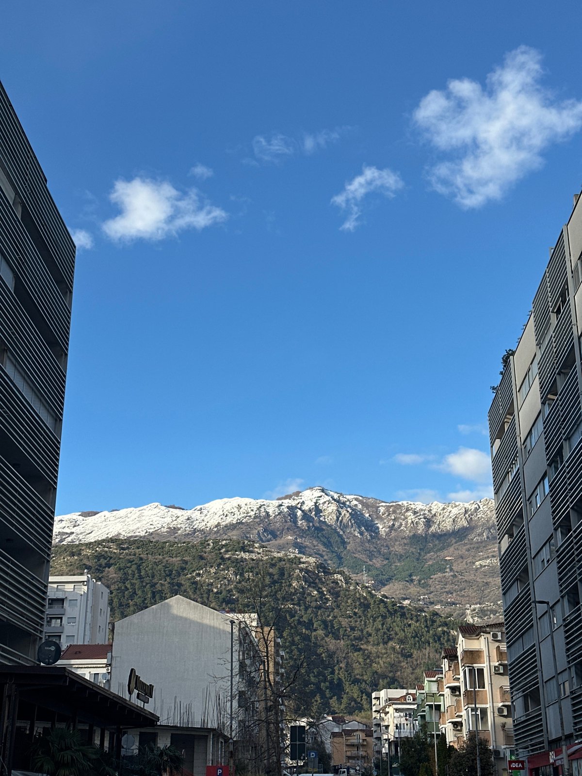 Tourist documents afternoon walk through Budva, Montenegro streets