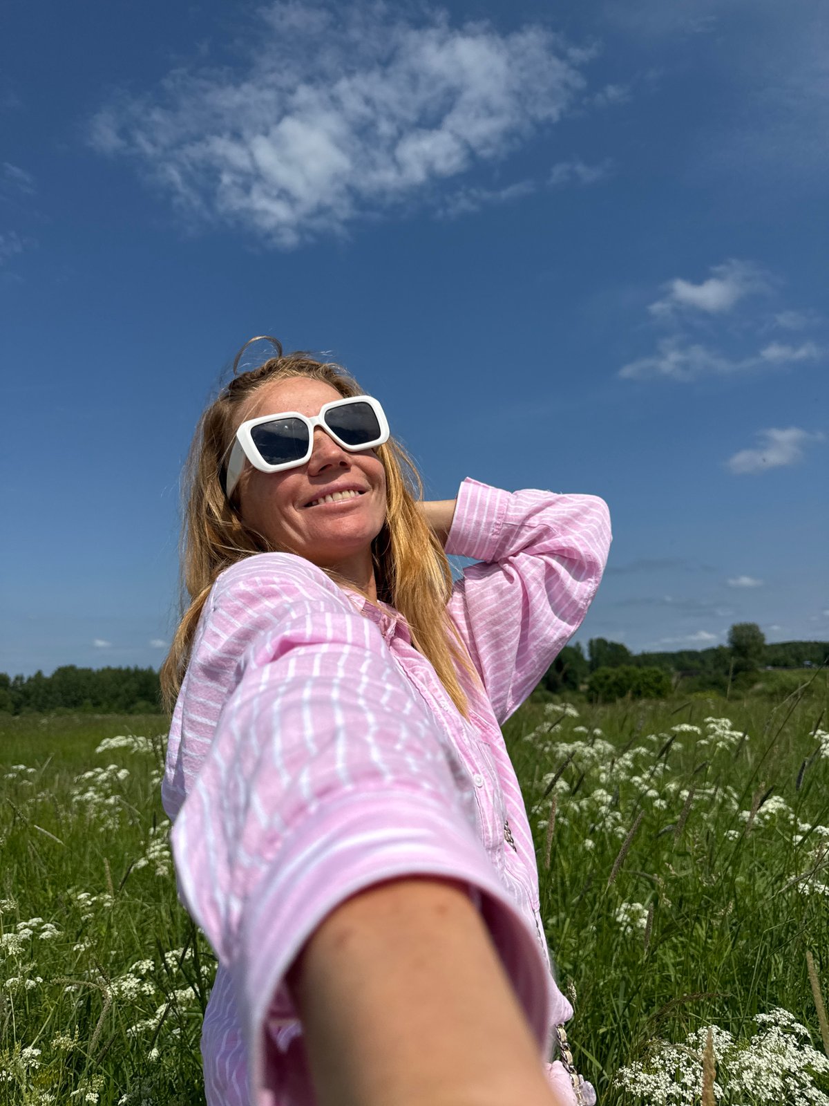 Woman documents wildflower meadow visit with selfies in Russia