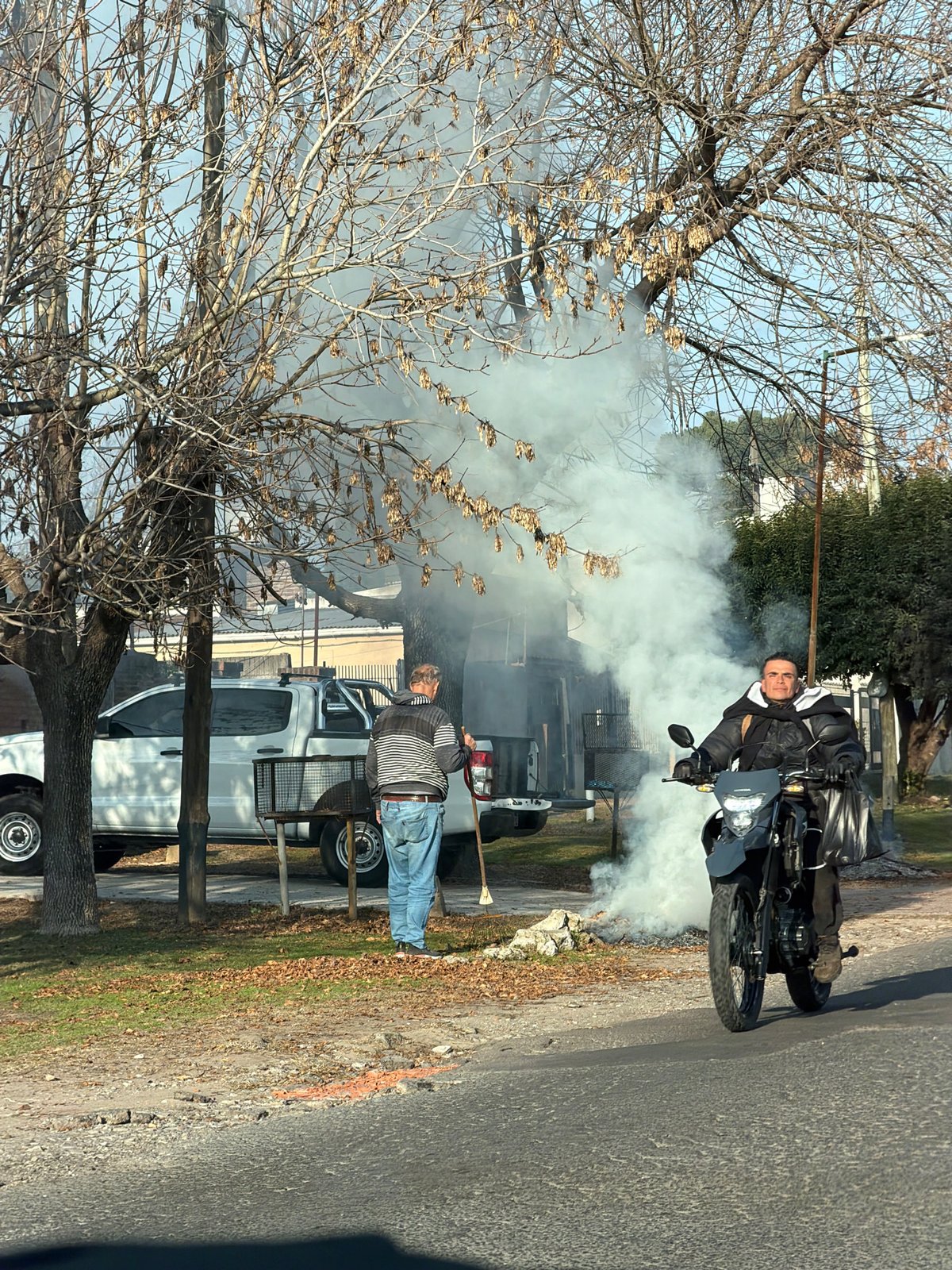 Street scene captured in San Carlos showing motorcyclist and pickup truck