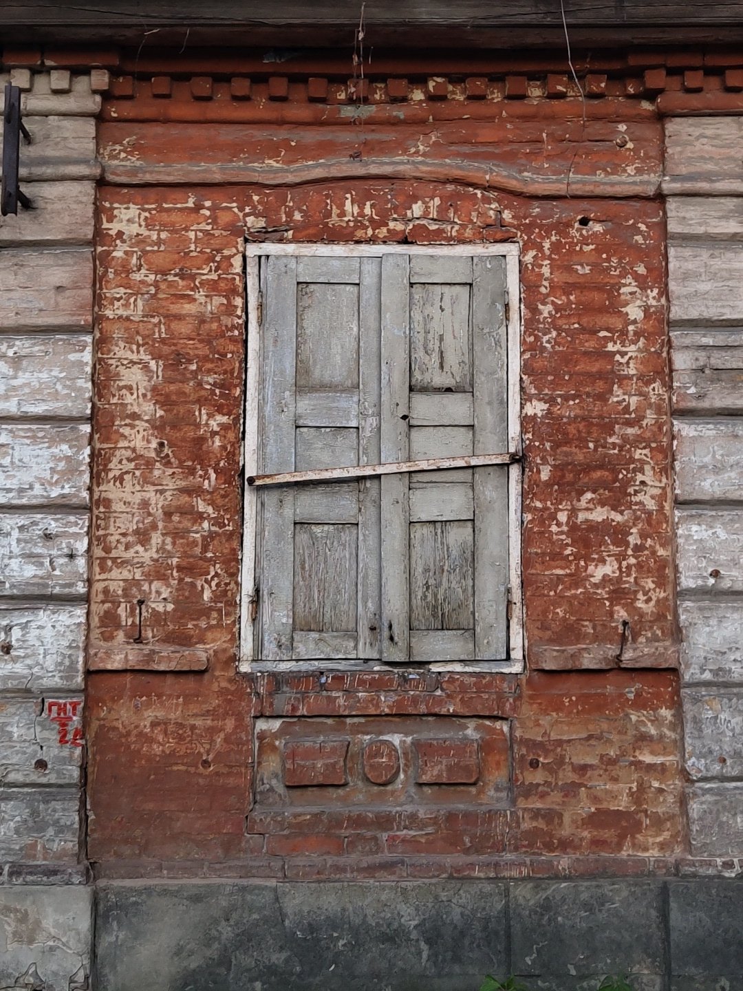 Weathered window documented on deteriorating wooden wall structure