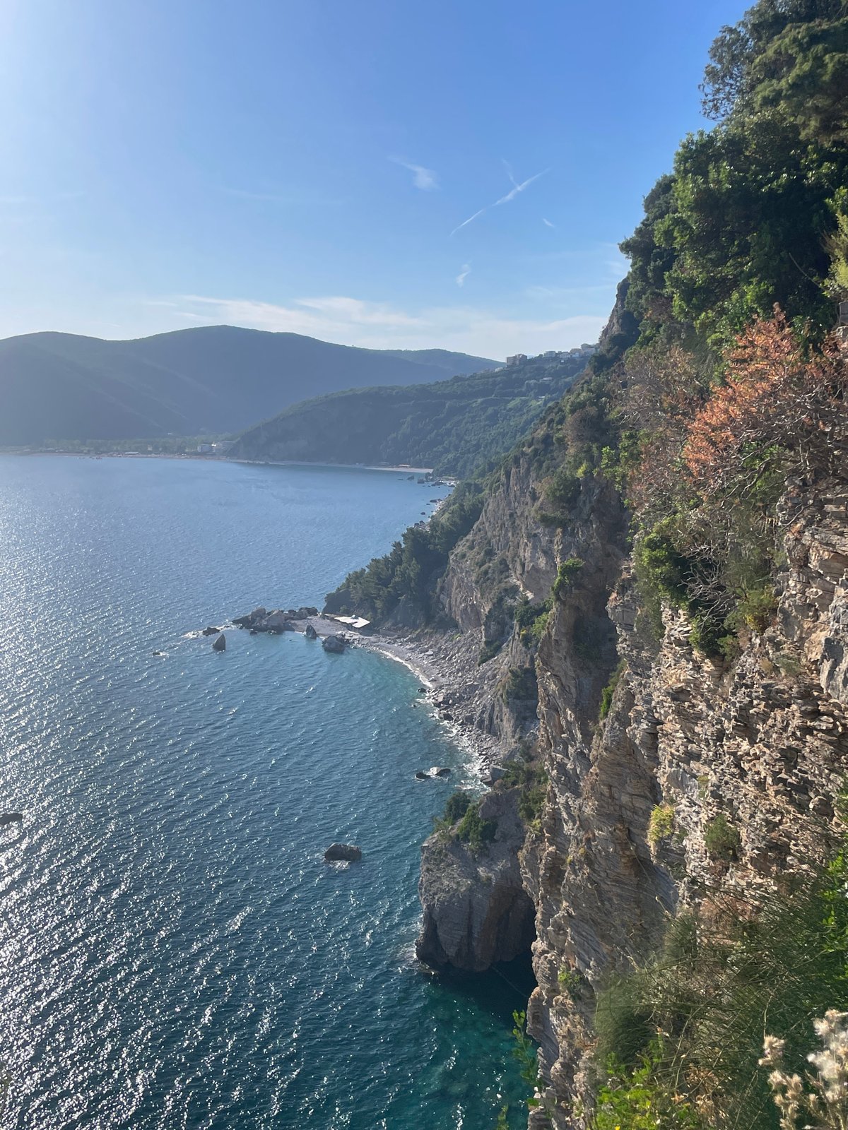 Tourist documents scenic Adriatic coastline views around Budva, Montenegro