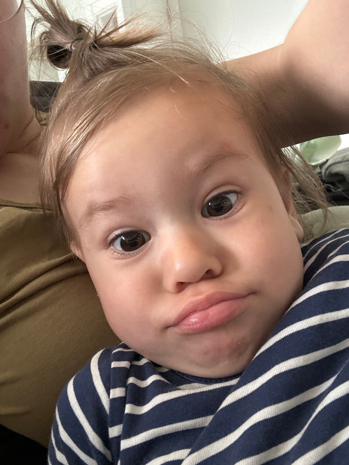 Mother and toddler share quiet morning moment on couch