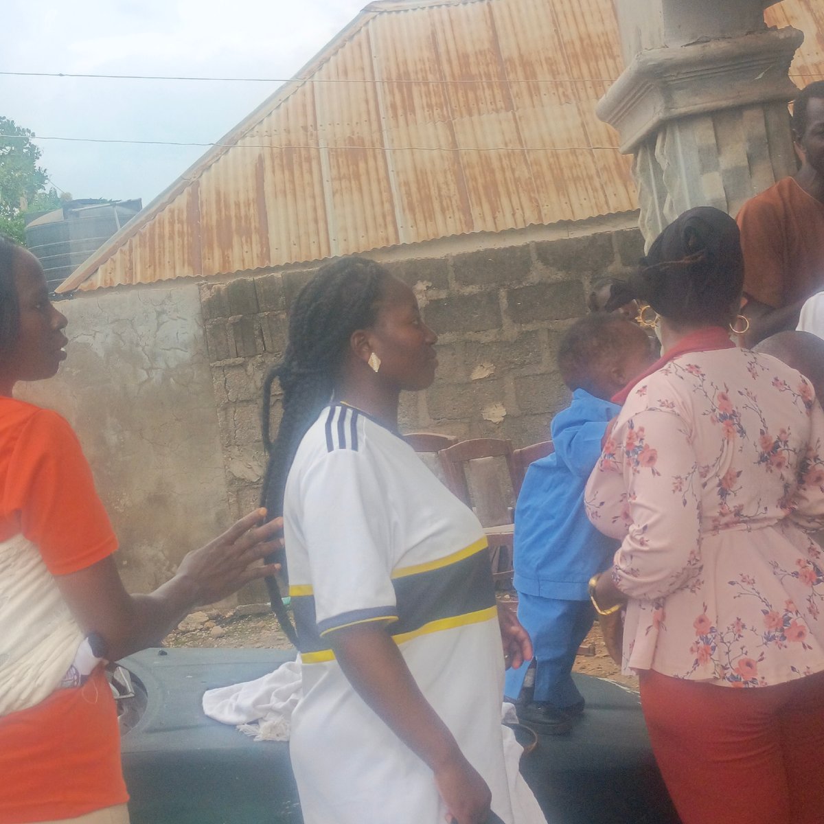 Community gathering outside residential building in Akwanga, Nigeria