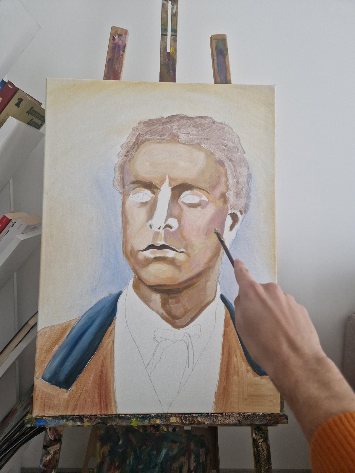 Artist paints male portrait on canvas early morning