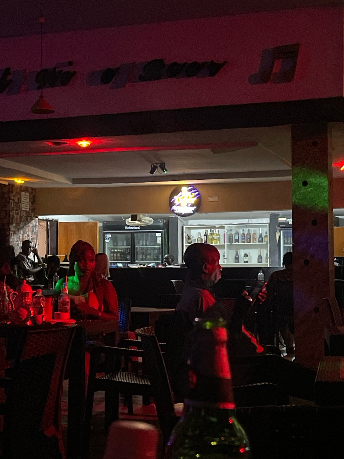 Bar patrons gather in Gura Top, Nigeria evening scene
