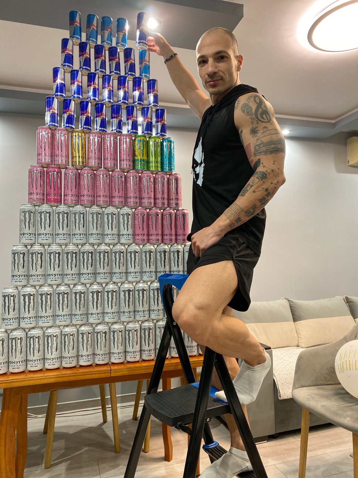 Man builds energy drink pyramid display in Pleven