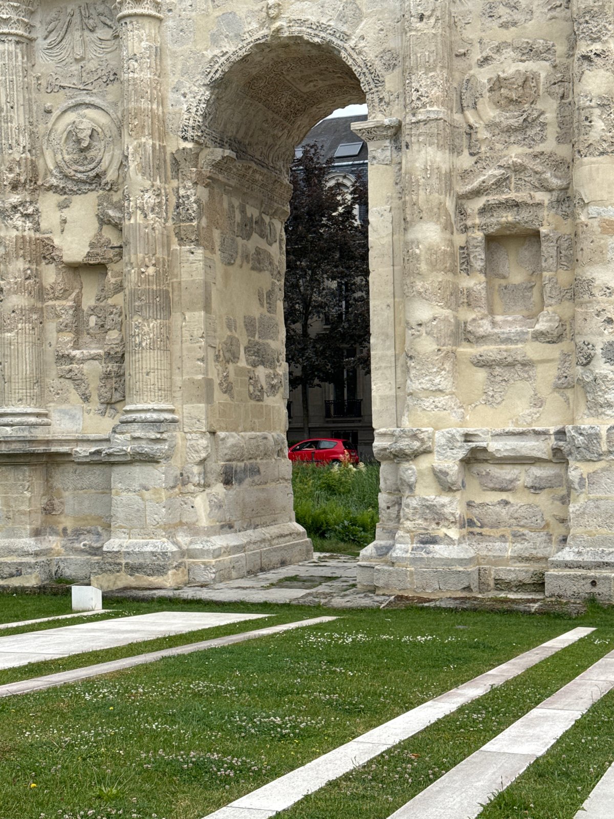 Tourist documents historic architecture during afternoon walk through Reims