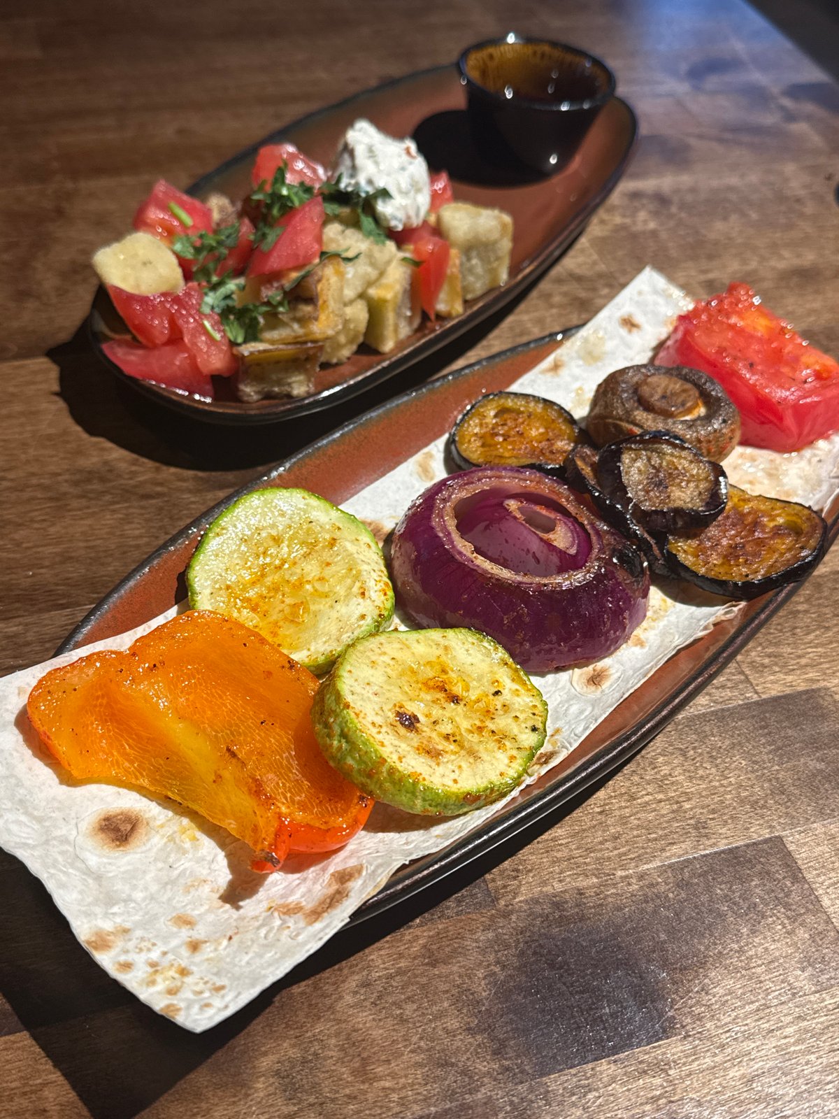 Restaurant spread of grilled vegetables, stews, and salads in Perm