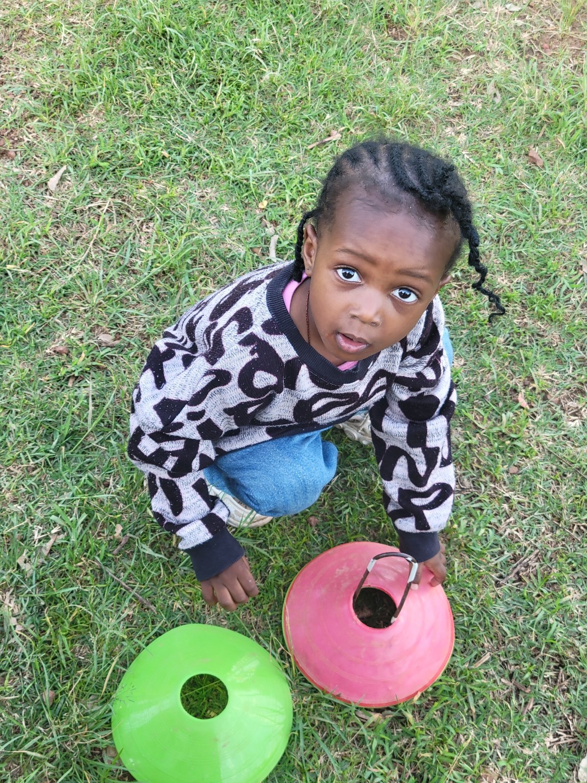 Children practice soccer and play on grassy field