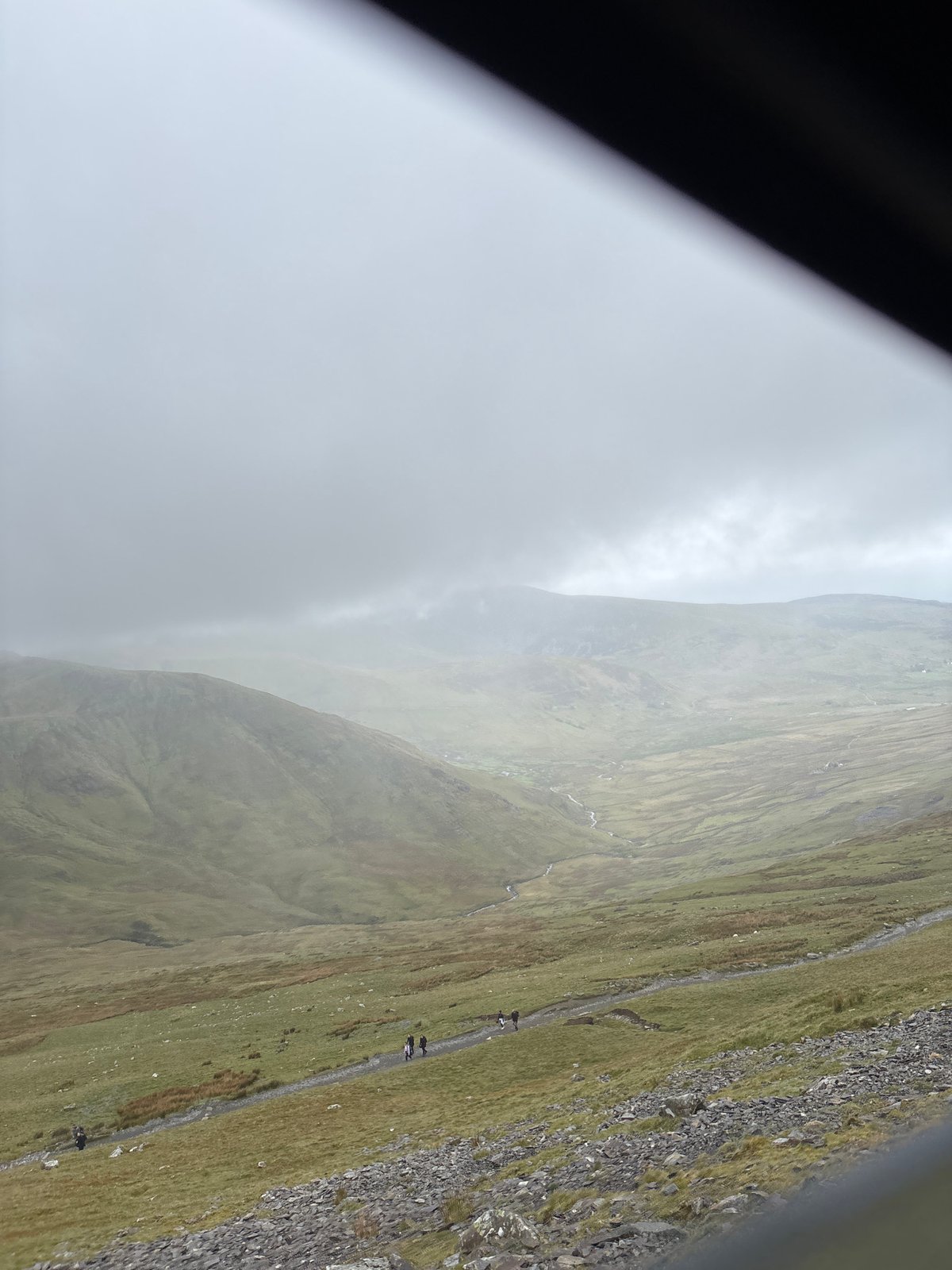Hikers traverse mountain path in Llanberis, Wales