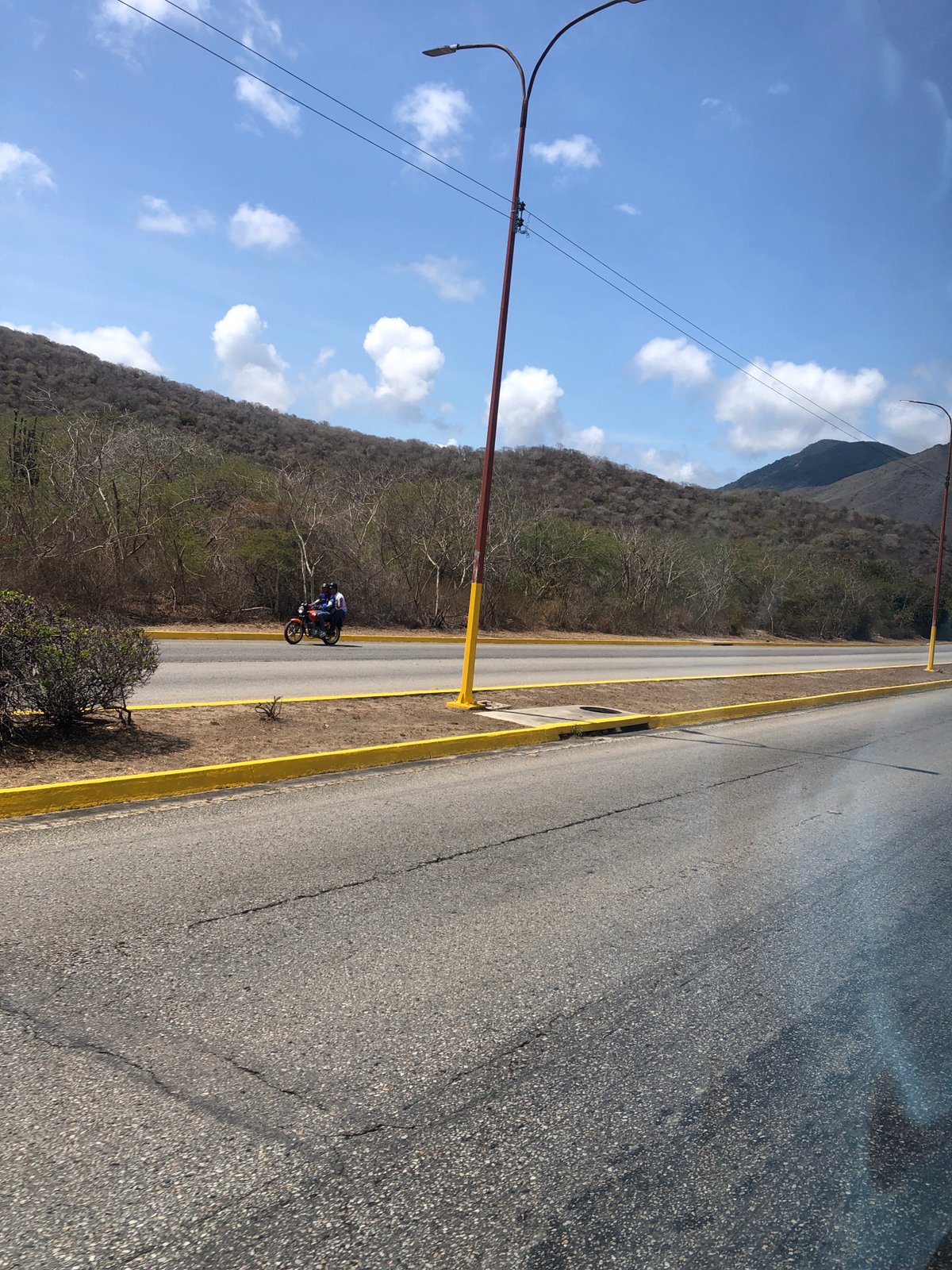 Motorcycle rides median strip on La Asuncion road