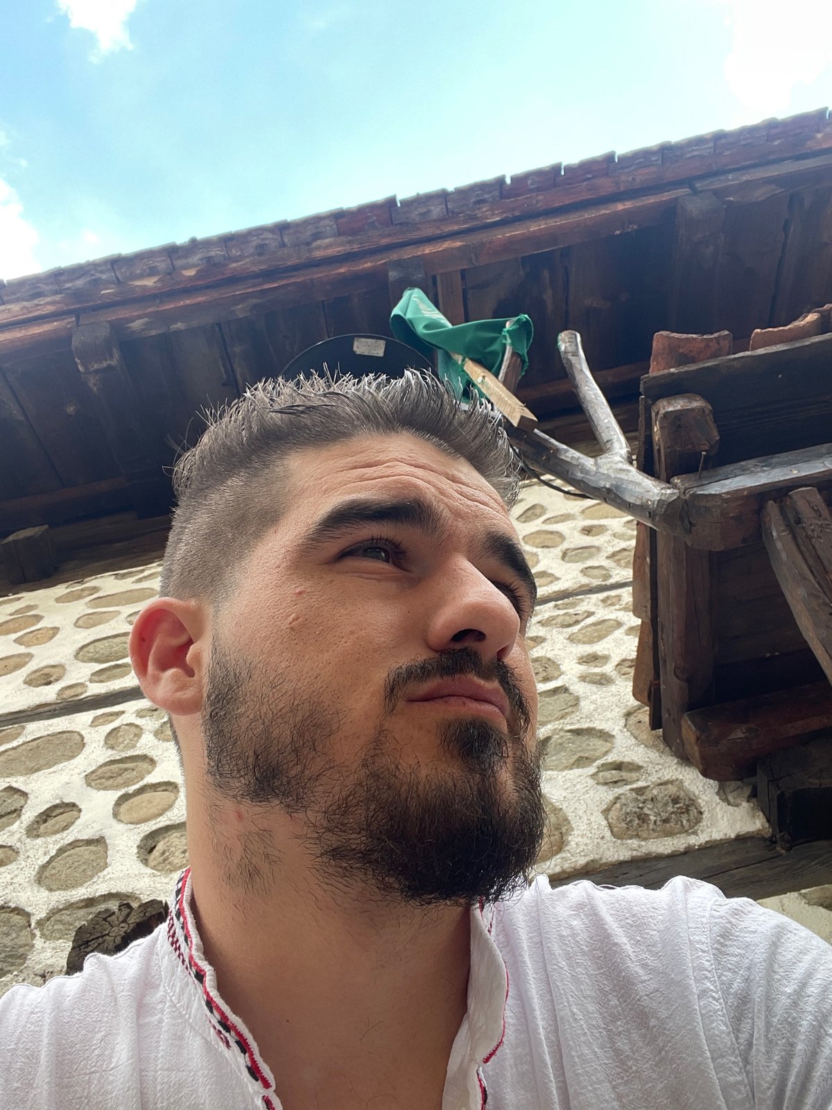 Selfies in traditional dress at a stone building, with casual text graphics