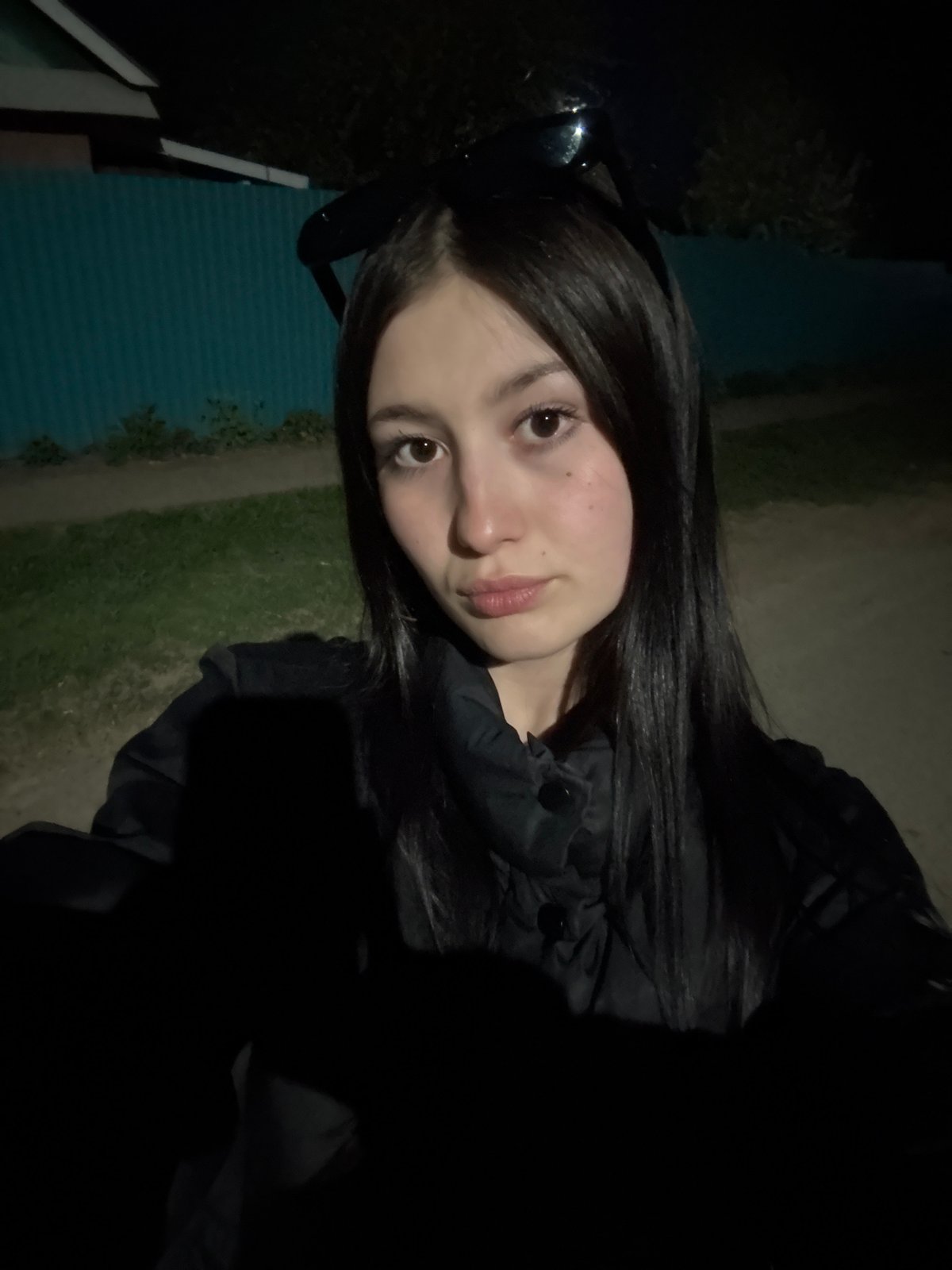 Woman takes evening selfies in residential Фоки, Russia