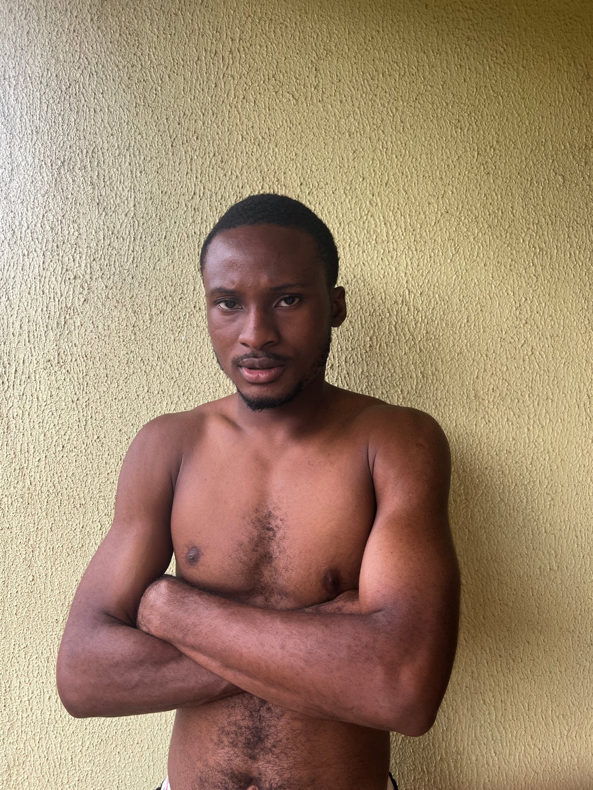 Two people captured in casual indoor moments in Makurdi