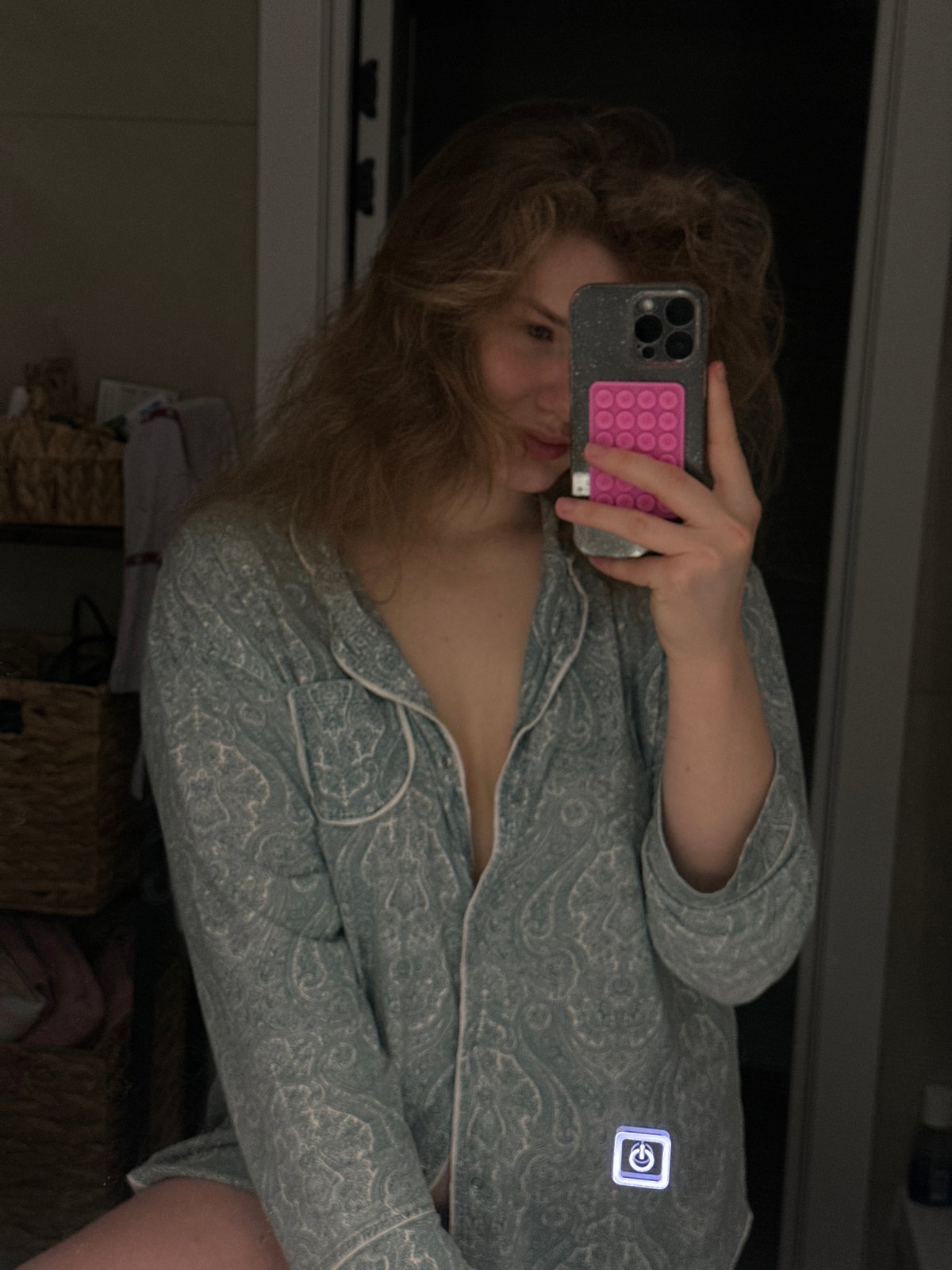 Woman takes mirror selfie in patterned pajamas in Kazan