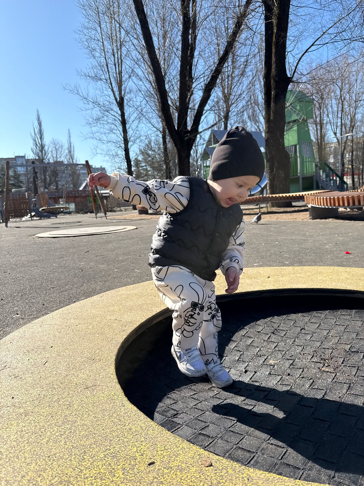 Child in winter clothing spotted on playground equipment