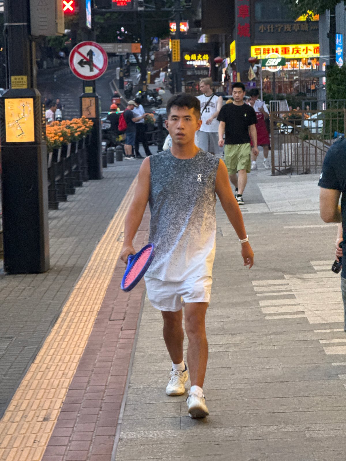 Quiet midday street activity on a Yuzhong District sidewalk