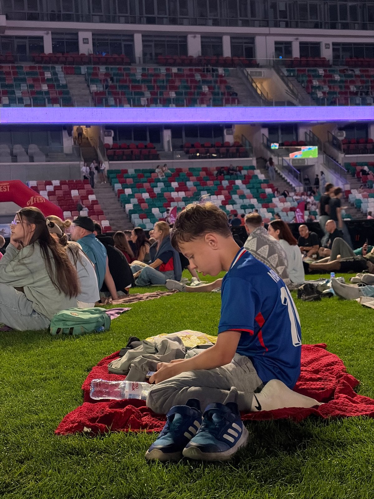 Crowd gathers at Dinamo Stadium for live football broadcast