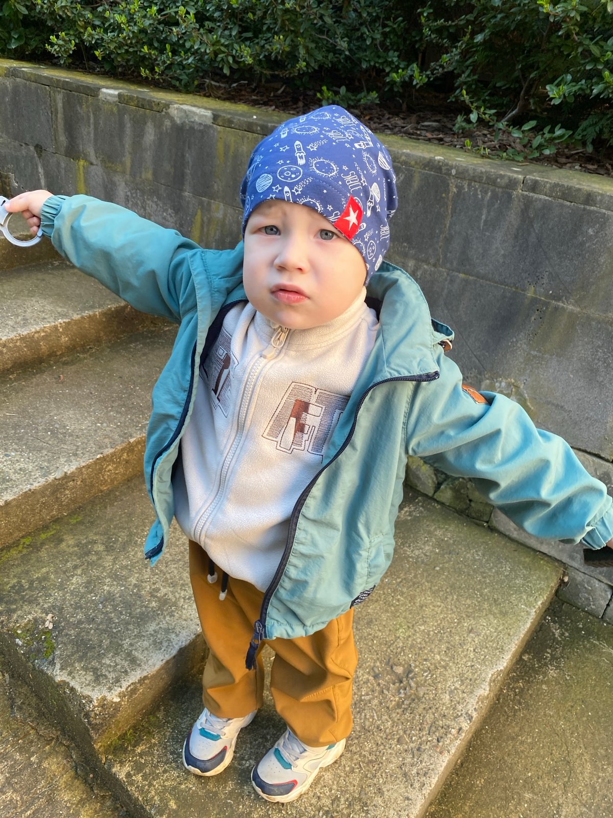Child in space-themed outfit climbs stairs in Sochi