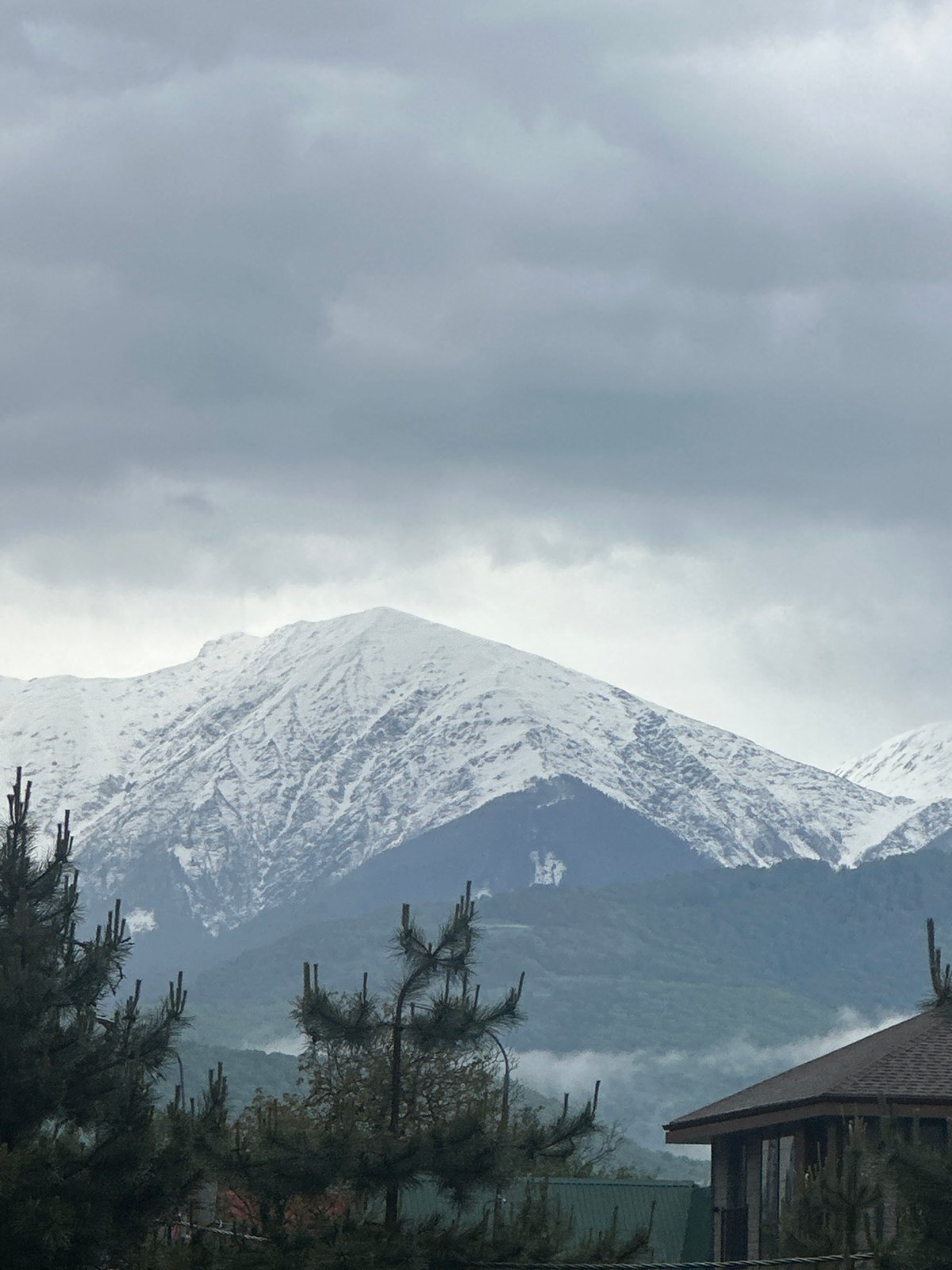 Overcast skies blanket snow-dusted mountains in Krasnaya Polyana